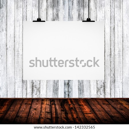 Interior of empty room with white paper hanging on paper clips