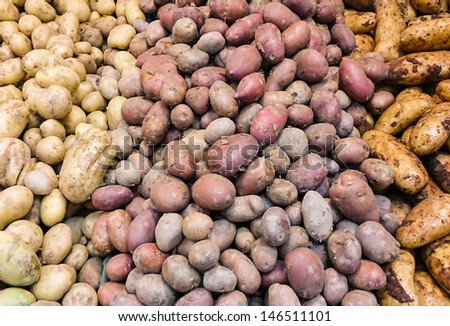 Various types of fresh potatoes at market
