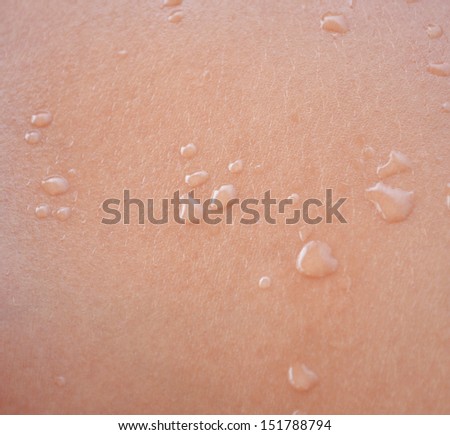 Water drops on human skin macro shot