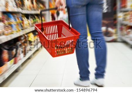 Hand holding empty shopping basket - Shopping concept
