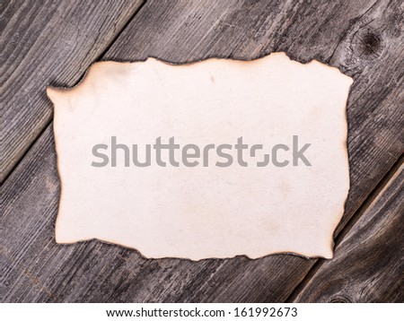 Old paper sheet over wooden background