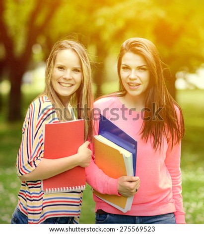 Happy students in summer park