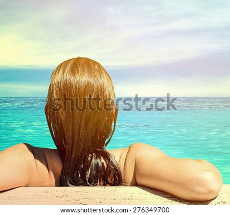 Back view of relaxed woman in blue water