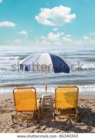 Two loungers under sun umbrella at the beach