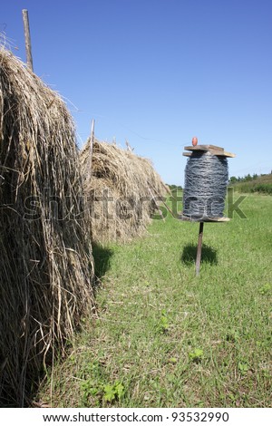 Traditional norwegian hay drying rack, hesje, and a roll of wire