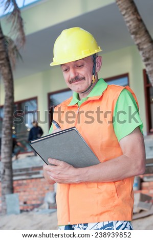 Portrait of a foreman on a construction background