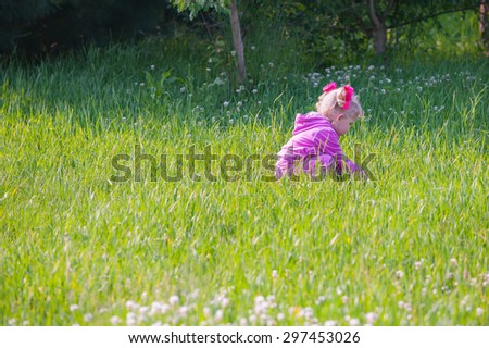 Little girl, playing in a meadow, don\'t get lost in the woods...