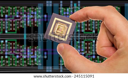 Microprocessor in hand in front of chip layout