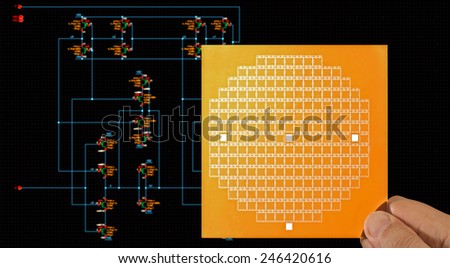 Chip mask in hand over circuit schematic diagram