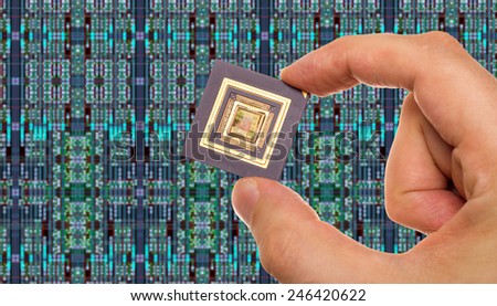 Microprocessor in hand in front of chip layout