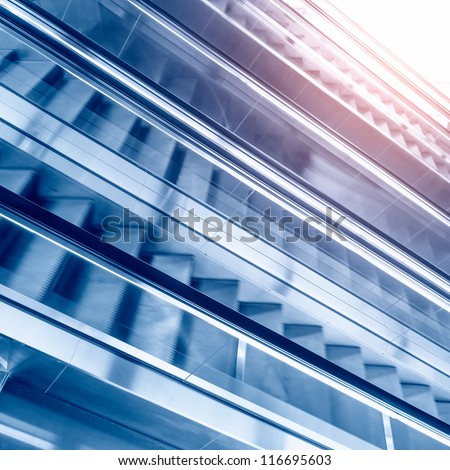 People rush on escalator motion blurred. shopping abstract