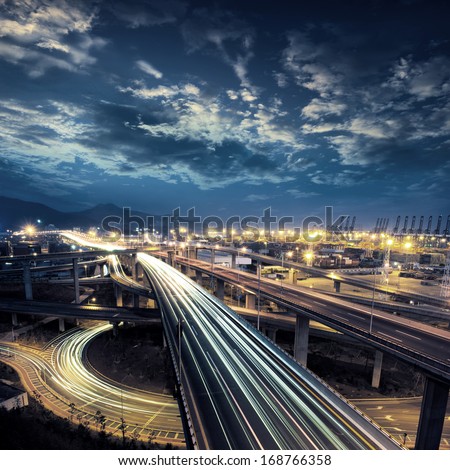 Freeway in night with cars light in modern city