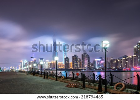 beautiful shanghai bund with curved light trails on the street in evening