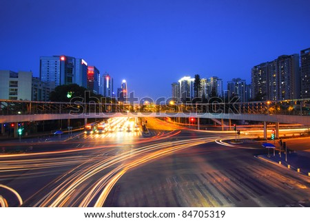 road with car traffic at night and blurry lights showing speed and motion