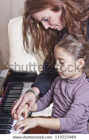 Piano player and her student during lesson