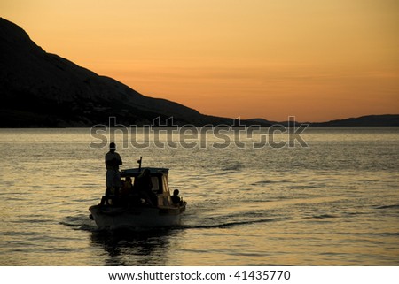 Boat go back home at the sunset