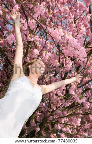 Flying woman in cherry blossom