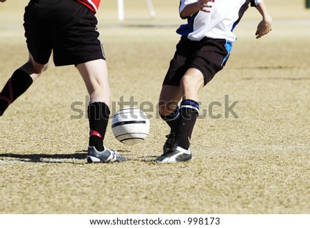 A fight for the soccer ball in a youth soccer game.
