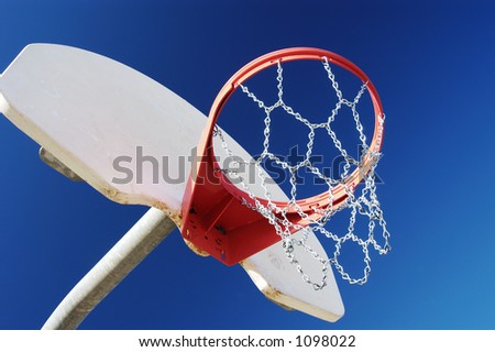 Basketball hoop with chain net in a city park.