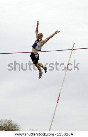 A competitor in the men\'s pole vault event during a college track meet.