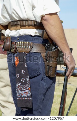 Contestant in period dress wait to compete in a cowboy action shooting event.