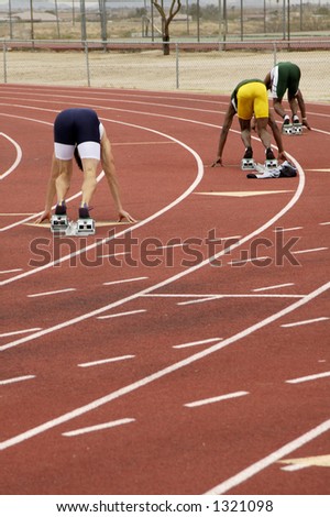 Start of the men\'s 400 meter run during a college track meet.