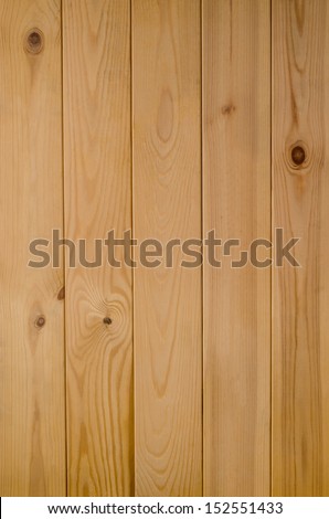 Photograph of a panel of light wood tongue and groove planking, shot vertically.