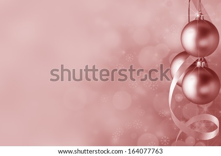 Festive pink Christmas baubles and spiral streamer on the right. Circles of bokeh glow, sparkling stars and snowflakes in the background fading towards solid colour copy space on the left side.