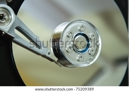 Close up (macro) of an exposed hard disk platter and read/write mechanism.