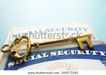 Social Security cards and old gold key - retirement concept
