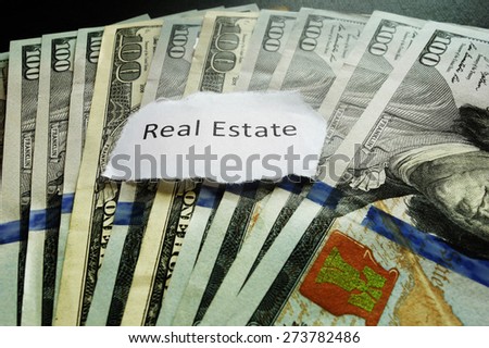 Real Estate paper note on hundred dollar bills