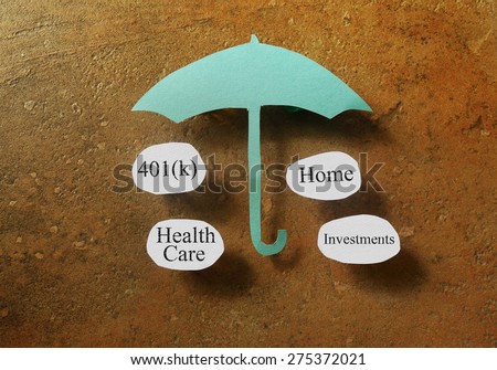 Retirement and investing terms under a paper umbrella - retirement planning concept