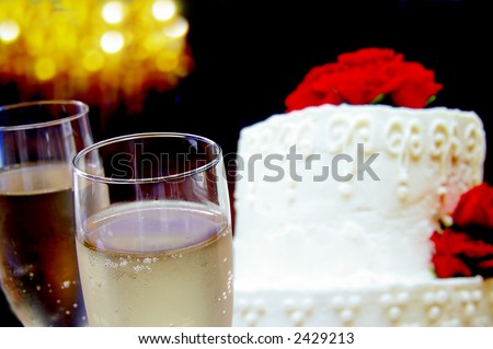 Wedding cake with flowers and champagne glasses