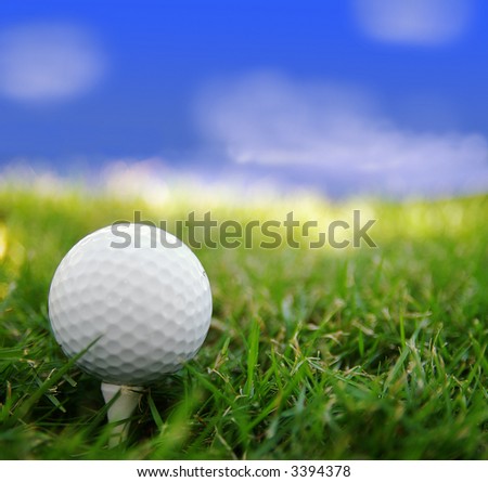 Golf ball closeup, on a tee, and sky