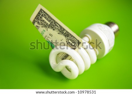 Compact fluorescent light bulb, with a dollar bill