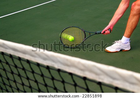 Tennis player running and hitting the ball