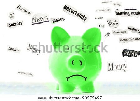 frowning pink piggy bank with bad economic news headlines