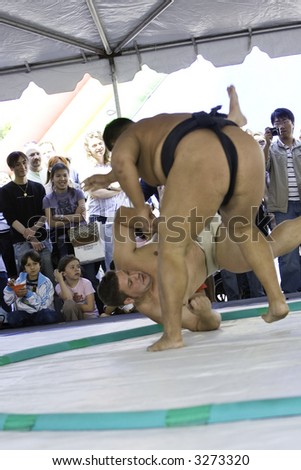 4-01-07 Heavyweight USA Sumo contenders at the Los Angeles Cherry Blossom Festival during an exhibition.  One opponent is thrown to the ground.