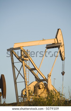Image of a pumpjack type oil pump.  Also known as a nodding horse, nodding donkey, thirsty bird, beam pump or horsehead pump.