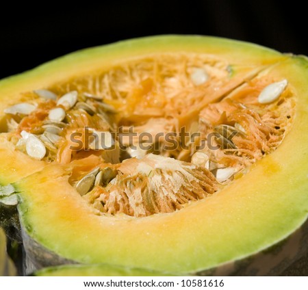 A close up of a melon cut open with seeds