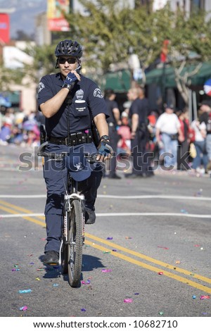 Los Angeles Chinatown, Feb 9th, 2008: Police officer on a bicycle doing crowd control at the Chinese New Year parade, celebrating Year of the Rat.