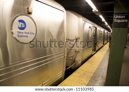 Manhattan, NY Dec 20th, 2007:   Horizontal image of a New York City subway with waiting commuters