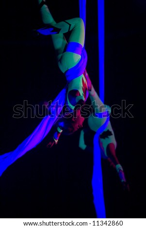 Circus Vargas, Culver City, CA Oct. 6, 2007:  Circus Vargas acrobat hanging of fabric in mid-air.