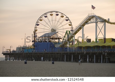 Santa Monica Beach, Santa Monica, CA May 3, 2008:  Horizontal image of the Santa Monica Pier with the prominent Ferris wheel and other thrill rides taken at dusk.