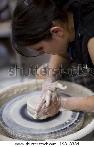 LAGUNA BEACH, CA AUG 31, 2008:  A potter works on a bowl on a potter's wheel at the Annual Laguna Beach Sawdust Art Festival.  Focus is on the wheel.