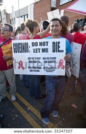 HOLLYWOOD - JUNE 5: APLA supporter, Jesus holds a sign at a rally against budget cuts in HIV/AIDS prevention and care programs by Sacramento on June 5th, 2009 in Hollywood, CA.