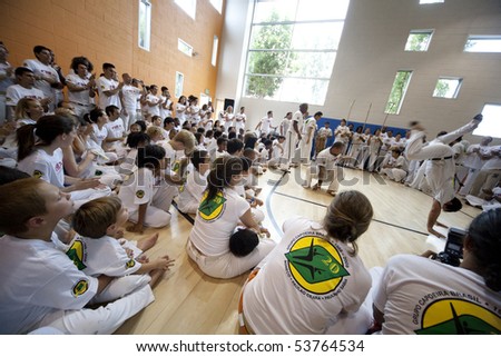 MANHATTAN BEACH, CA - SEPTEMBER 13: Capoeira students watch as two Mestres (masters) spar or \