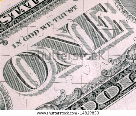 Money puzzle:  A close up of the American One Dollar Bill with a 20 piece jigsaw cutout.
