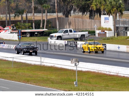 GAINESVILLE, FL - DECEMBER 6: From left, # 18, the driver of a black Pontiac racing against # 10 Tony Pawlish racing his 2004 Pontiac GTO at the NHRA Gainesville Raceway on December 6, 2009.