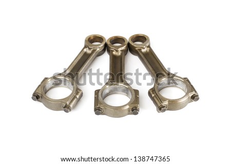 Three connecting rods from a car engine.